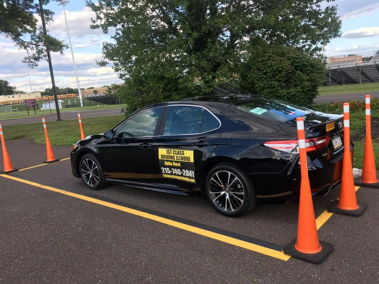 Parallel parking practice: the training car between orange cones in a marked space