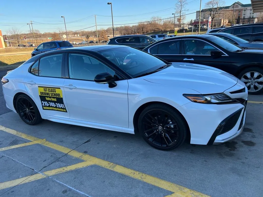 White driving-school Camry parked among cars in a Greater Philadelphia lot