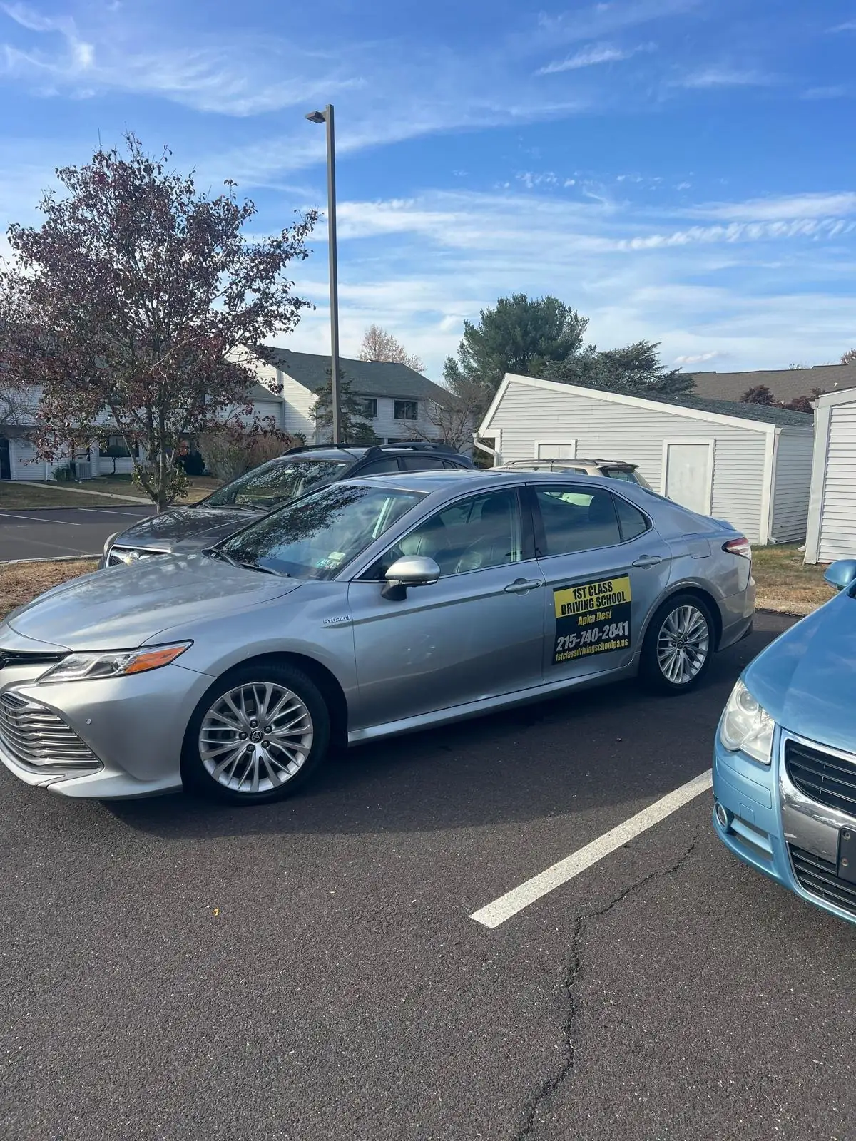 Silver Toyota Camry from the driving-school fleet parked in a lot